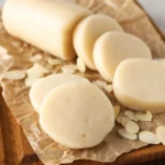 een staaf amandelspijs op een houten plank